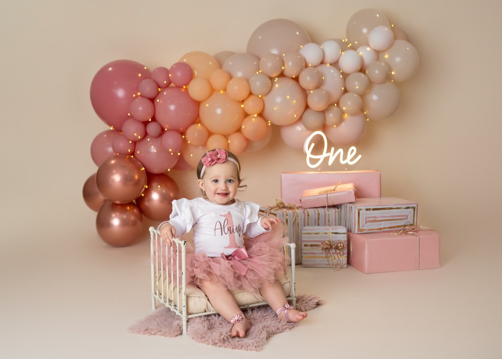 Sarasota upscale cake smash - baby posed for her formal photos on her custom designed cake smash set