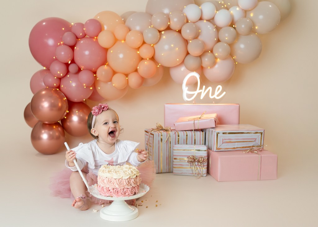 One year old girl during cake smash session in Sarasota