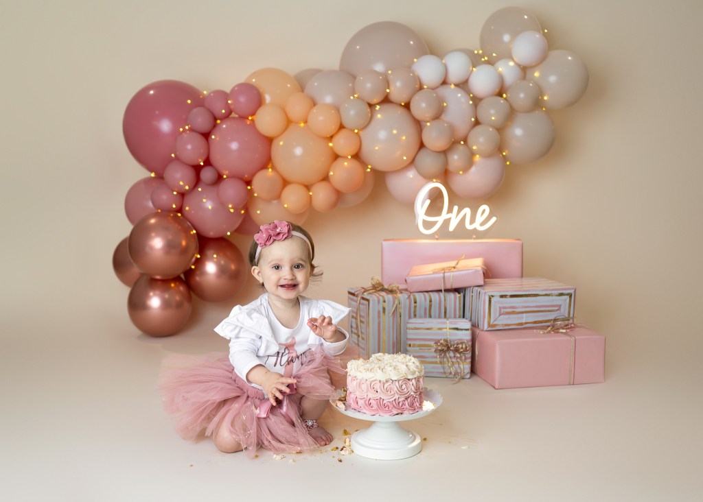 Baby girl exploring cake during Sarasota cake smash session
