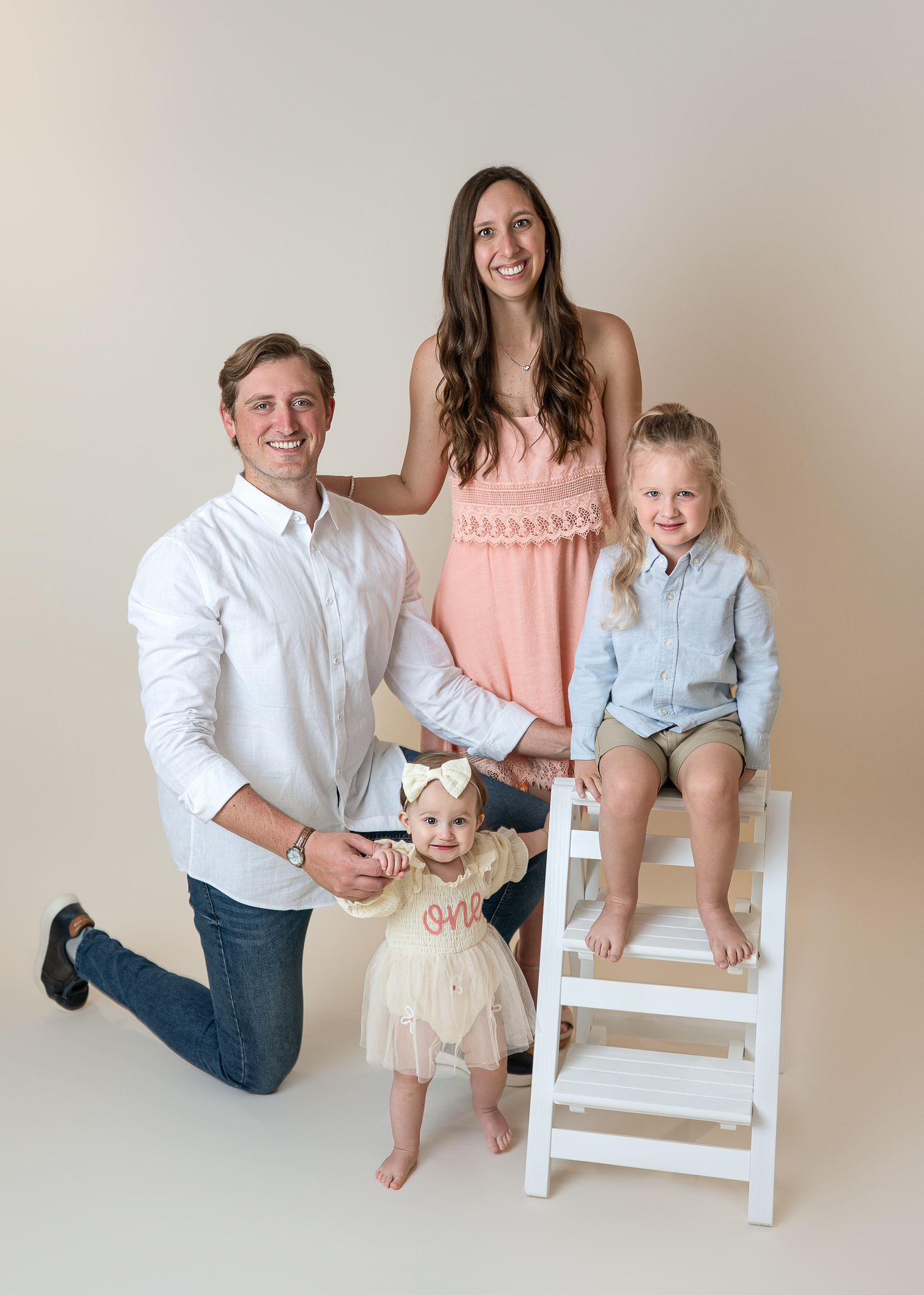parents posed with their son and daughter in a classic style family photo