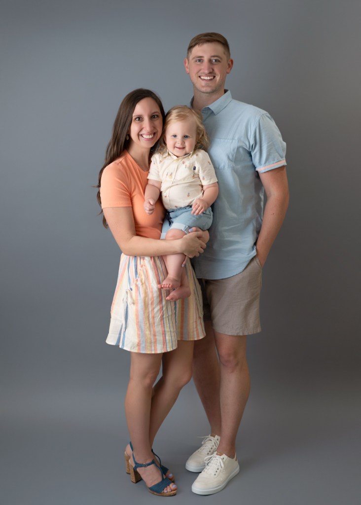 Parents holding their baby during a Sarasota studio family portrait.