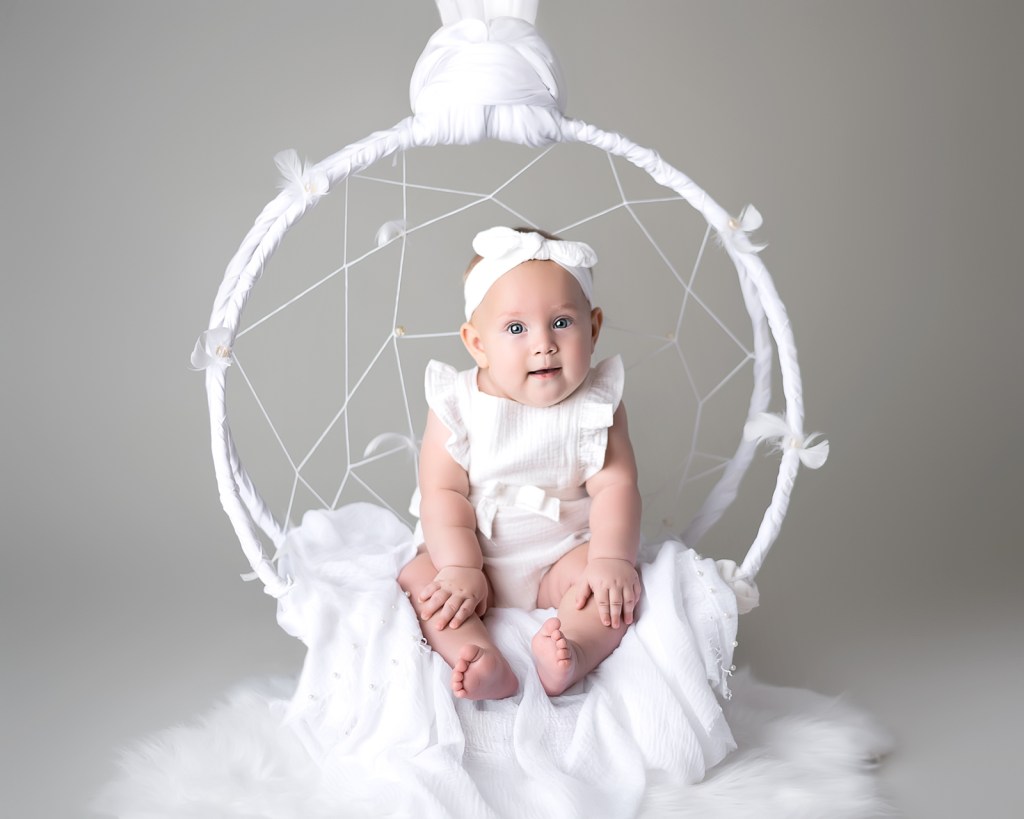 Six-month-old baby sitting for a milestone portrait in a Sarasota photography session